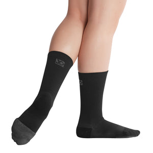 Female model wearing APOLLA Infinite Mid Calf Recovery Socks. Style: Infinite. Color: Black. View: Side, Back.