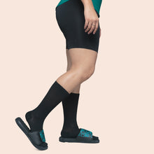 Load image into Gallery viewer, Male model wearing APOLLA Infinite Mid Calf Recovery Socks. Style: Infinite. Color: Black. View: Side
