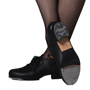 Female model wearing Capezio Cadence Tap shoe, shown in black.